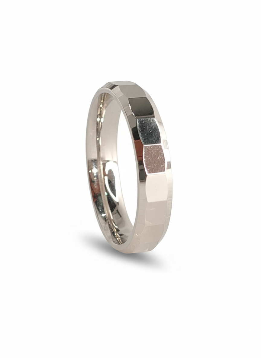 A front-on view of the sterling silver faceted ring, highlighting the reflective surfaces and modern, angular pattern of the band.