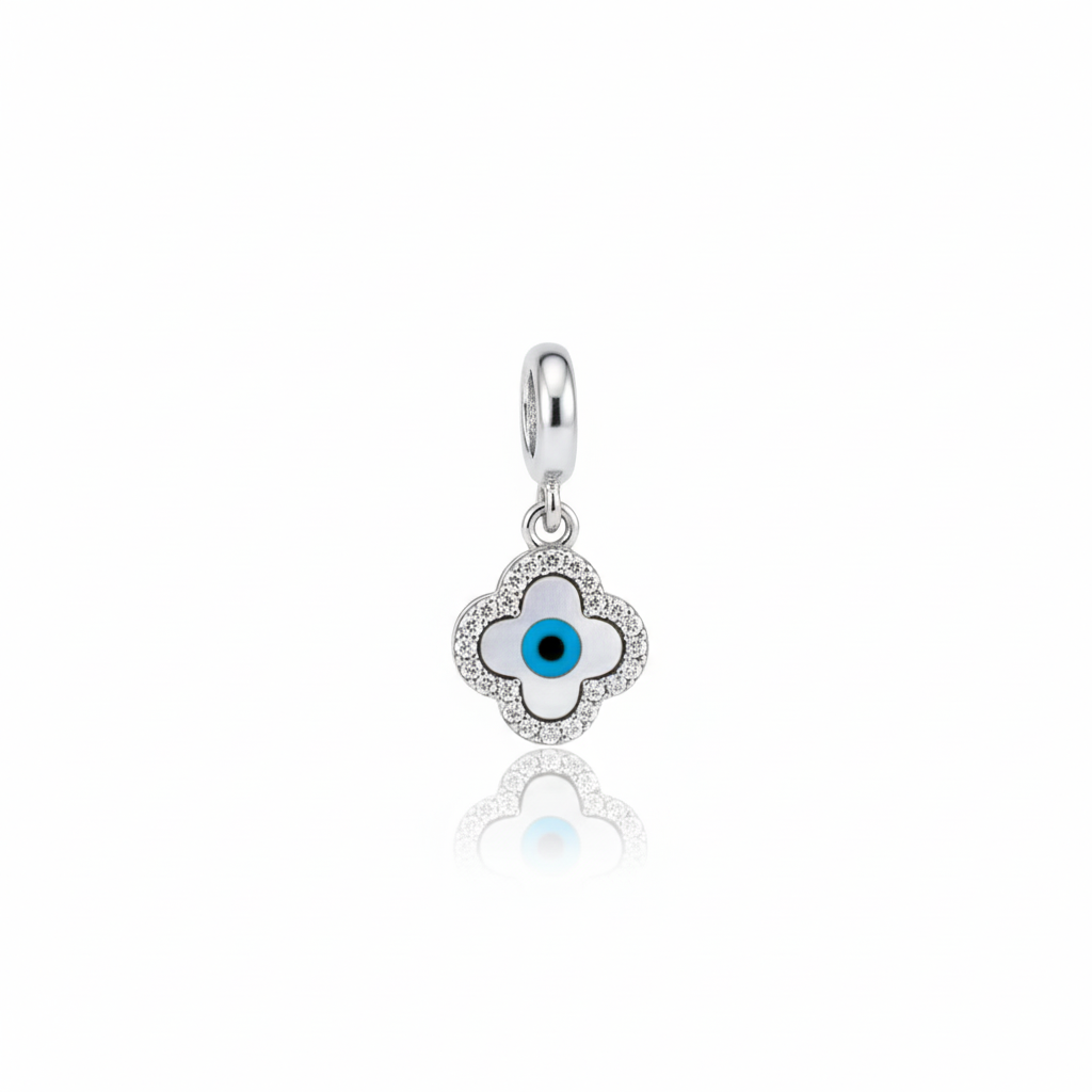 Close-up of The Aegis Clover charm: A sterling silver quatrefoil pendant with a blue and white Evil Eye center, surrounded by pave cubic zirconia stones.