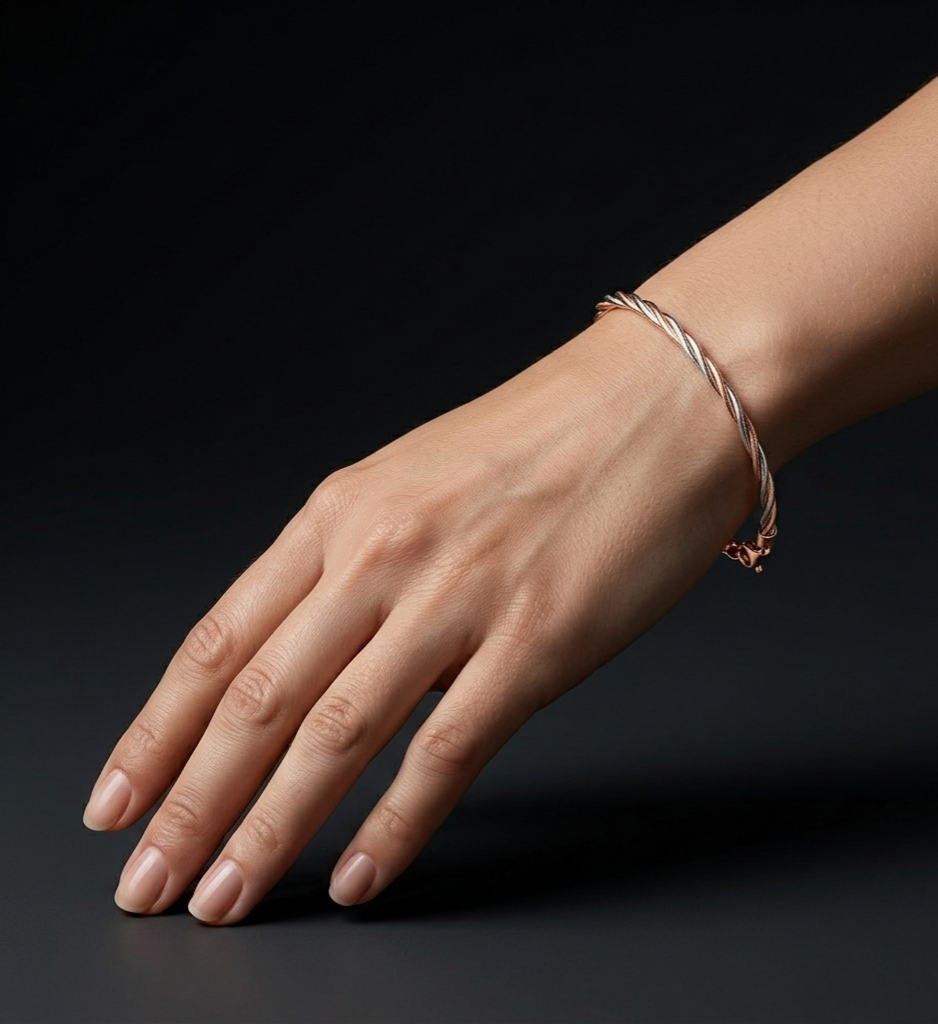 RoSé-ilver Spiral 925 sterling silver bracelet featuring an elegant rose gold and silver twisted rope design, worn on a woman's wrist