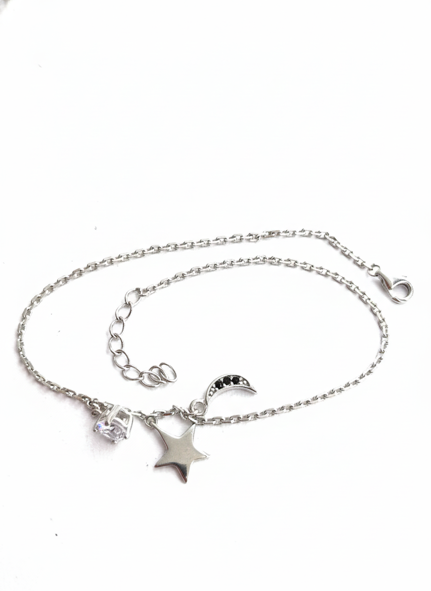 Starlit Moon 925 sterling silver bracelet with star, crescent moon, and crystal charms on a white background