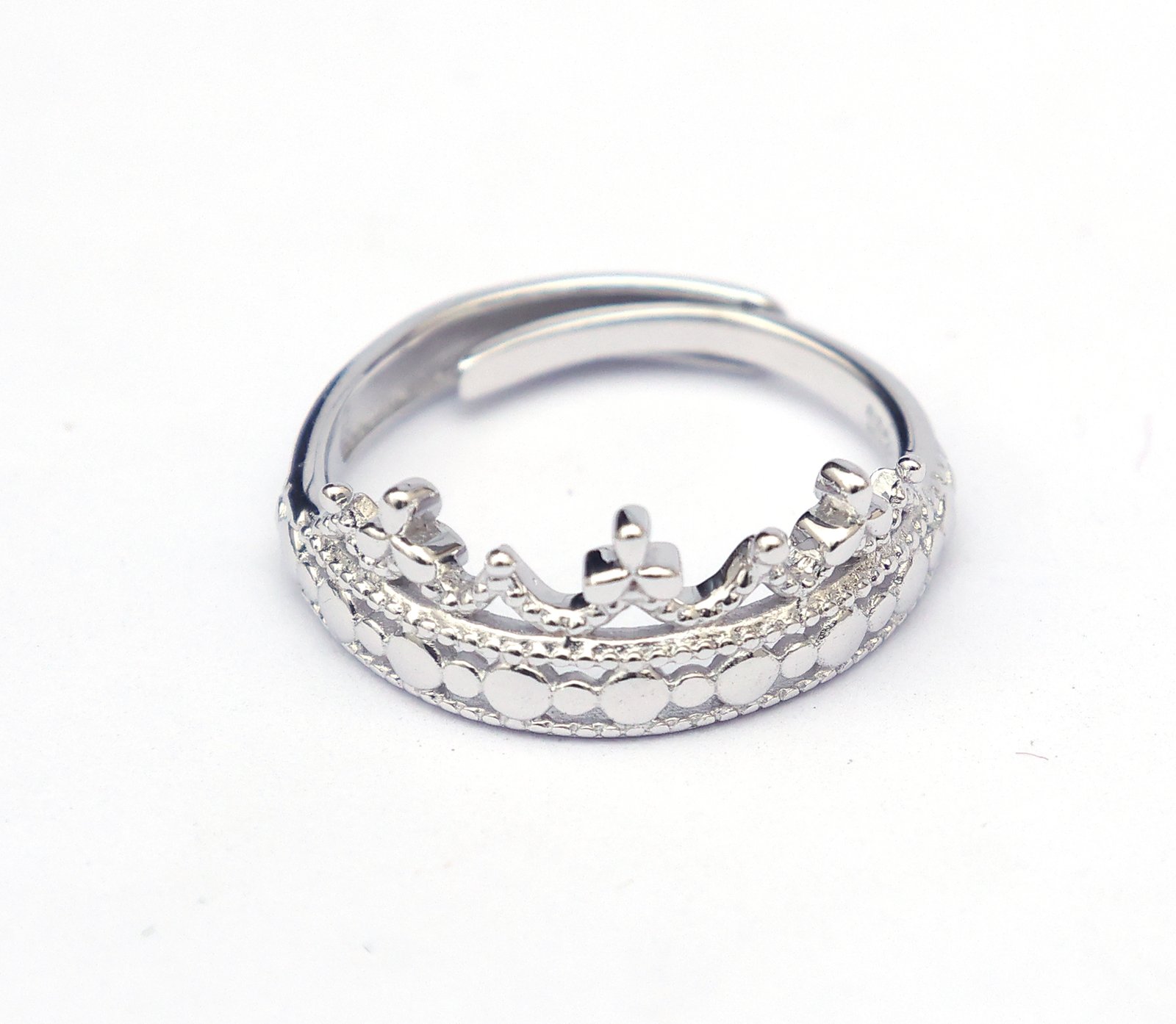 Close-up of clover crown sterling silver ring with intricate detailing