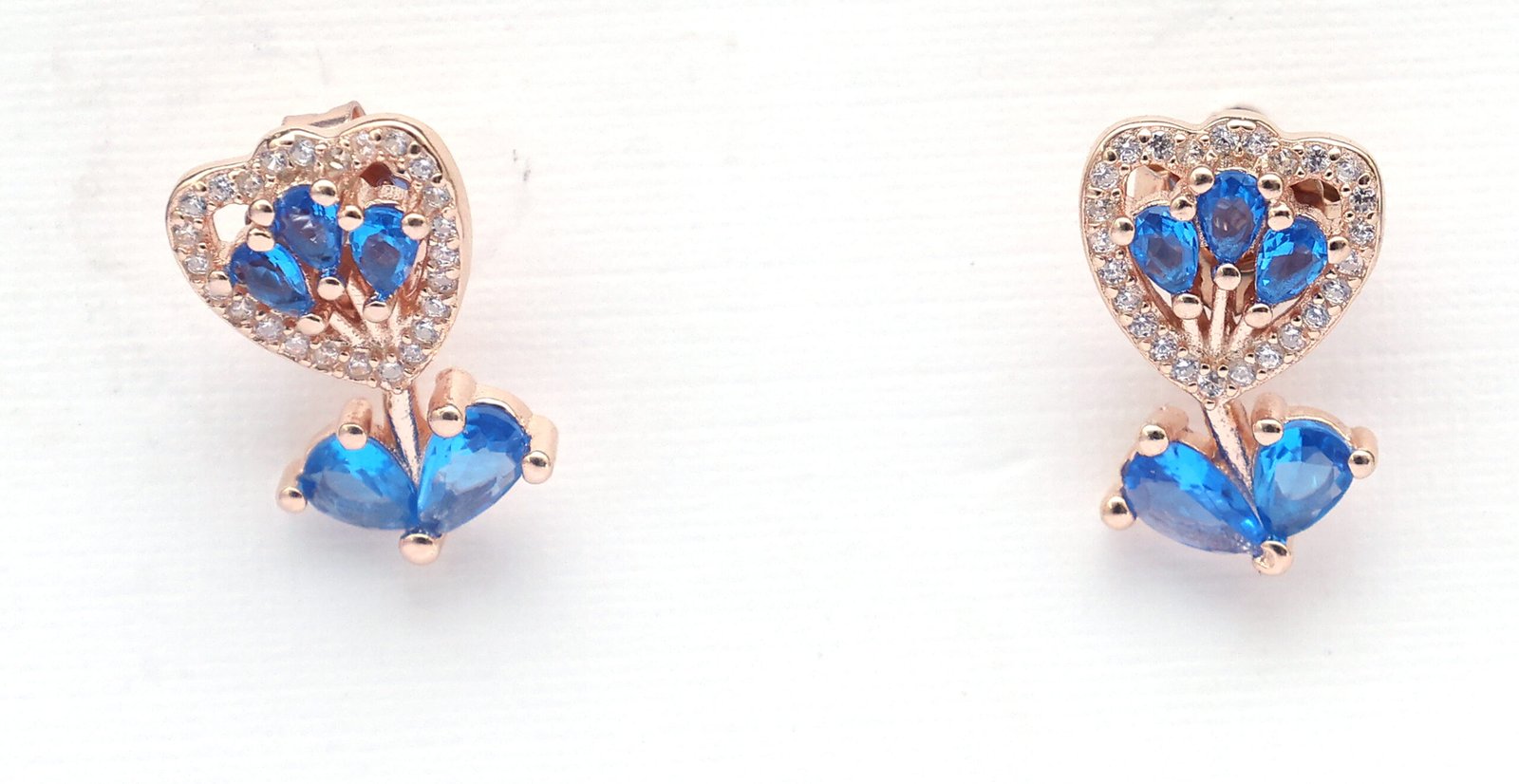 Close-up of blue blossom earrings with sparkling stones